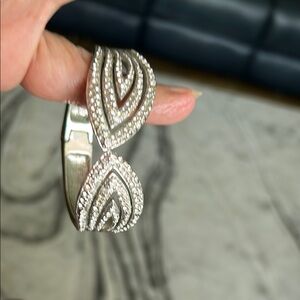 Sophisticated “ Nolan Miller” Silver Infinity Bracelet with Sparkling Stones